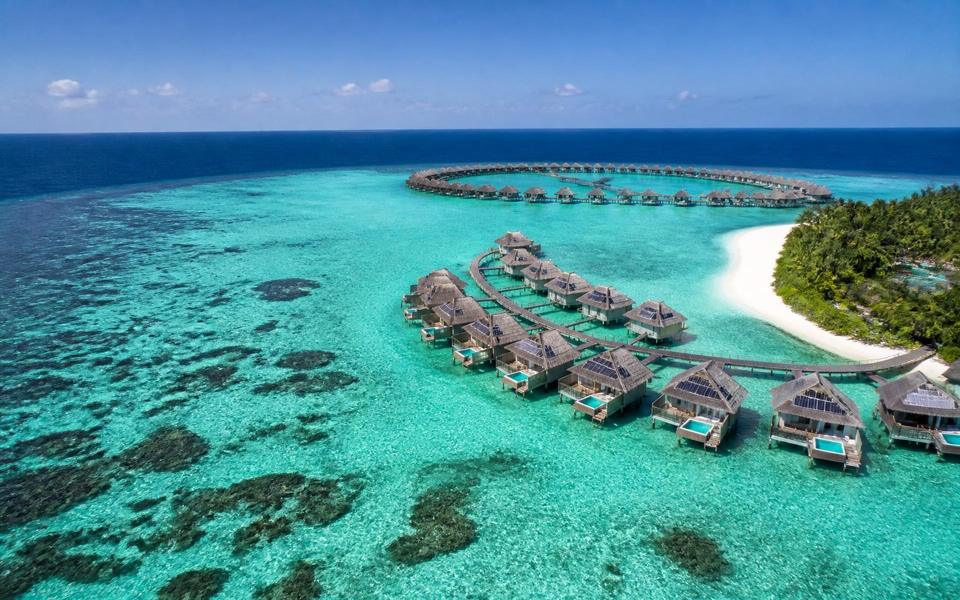 Overwater villas on a turquoise Maldivian lagoon