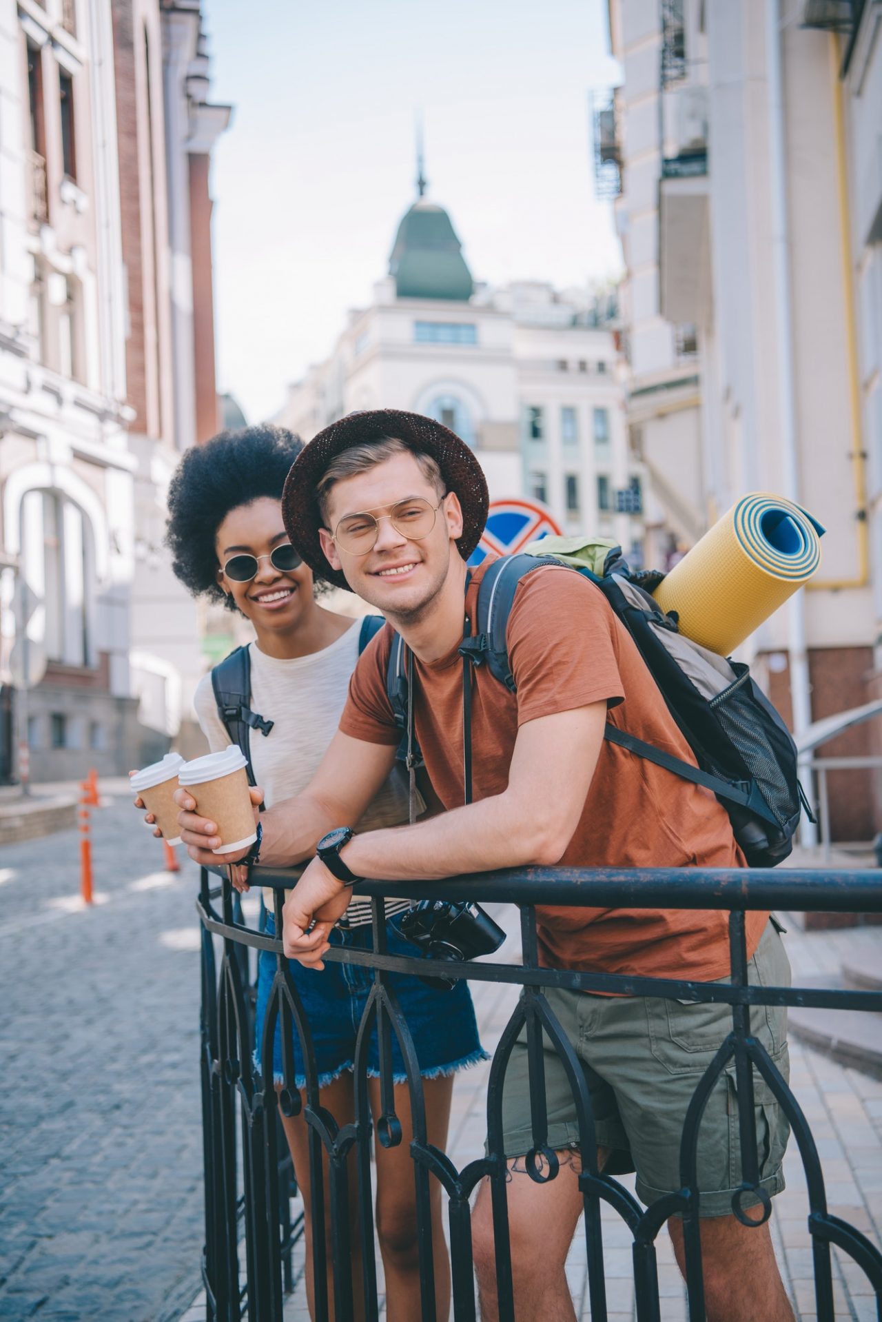 happy-young-interracial-couple-of-travelers-with-paper-cups-of-coffee Gallery